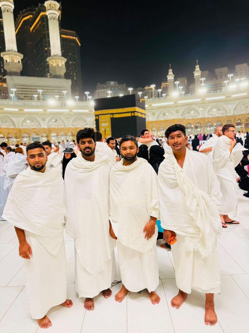 Aqsa International pilgrims in ihram at the Kaaba